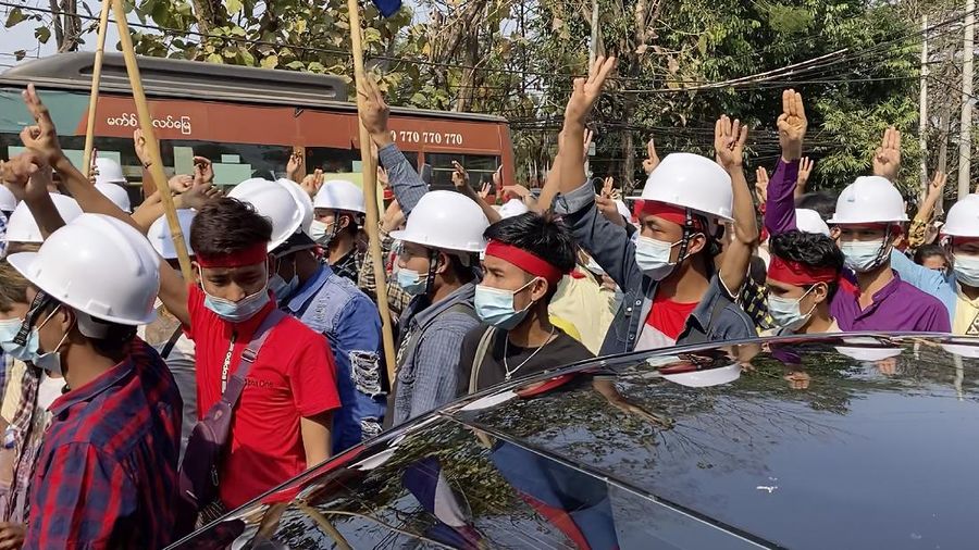 In this image made from video, protesters flash the three-fingered salute while they march Saturday, Feb. 6, 2021, in Yangon, Myanmar. The military authorities in charge of Myanmar broadened a ban on social media following this week’s coup, shutting access to Twitter and Instagram, while street protests continued to expand Saturday as people gathered again to show their opposition to the army takeover. (AP Photo)
