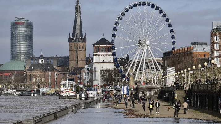 A promenade at the old town in Duesseldorf, Germany, is flooded by the river Rhine on Friday, Feb. 5, 2021. High tide caused by rain and melting snow threatens the commercial shipping on Germany's biggest river Rhine. (AP Photo/Martin Meissner)