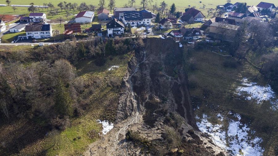 A railroad crossing is surrounded by floodwaters from rain and melting snow in Nidderau near Frankfurt, Germany, Wednesday, Feb. 3, 2021. (AP Photo/Michael Probst)
