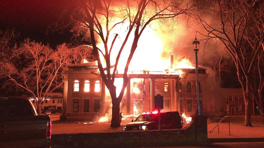This photo provided by Mason County Judge Jerry Bearden shows a fire at the Mason County Courthouse, Thursday, Feb. 4, 2021, in Mason, Texas. An official says a suspect has been taken into custody following the massive fire that destroyed all but the rock outer walls of the 111-year-old courthouse. Fire investigators suspect arson in both the courthouse fire and a fire around the same time at a house about a mile away. (Mason County Judge Jerry Bearden via AP)