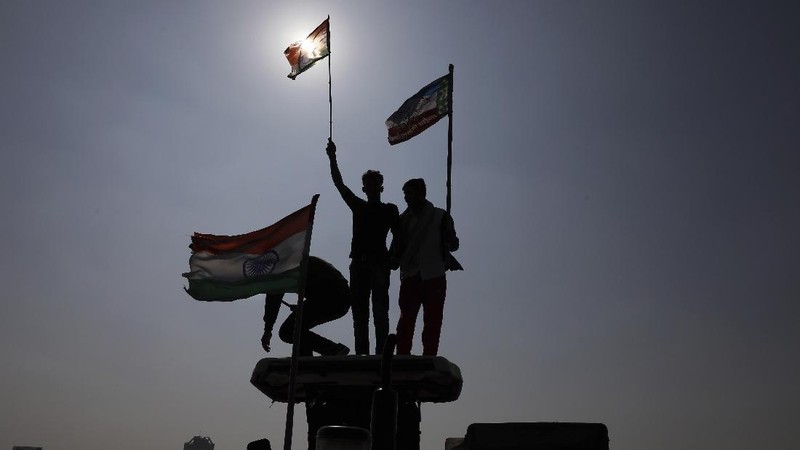 A woman participates in a protest against new farm laws in Mumbai, India, Saturday, Feb. 6, 2021. Tens of thousands of protesting Indian farmers blocked highways across the country for three hours Saturday to press their demands for the repeal of new agricultural laws. (AP Photo/Rafiq Maqbool)