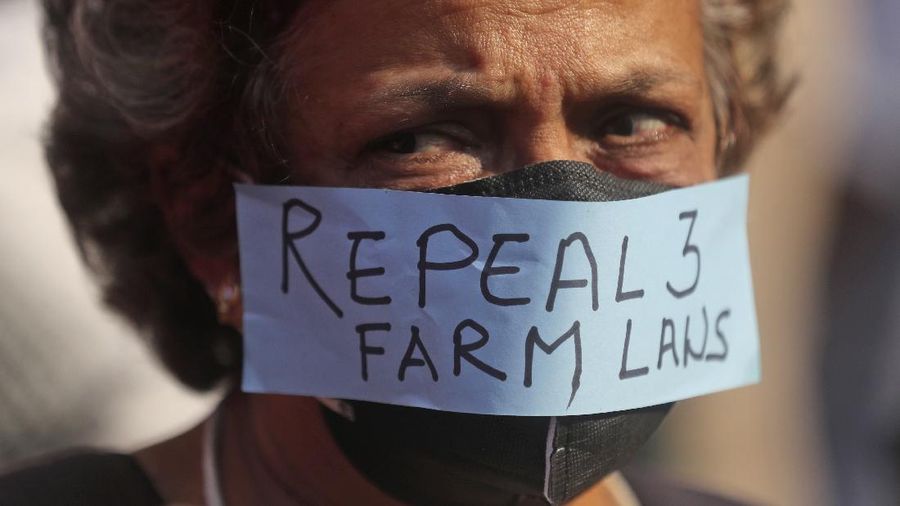 A woman participates in a protest against new farm laws in Mumbai, India, Saturday, Feb. 6, 2021. Tens of thousands of protesting Indian farmers blocked highways across the country for three hours Saturday to press their demands for the repeal of new agricultural laws. (AP Photo/Rafiq Maqbool)