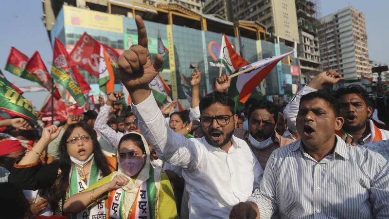 A woman participates in a protest against new farm laws in Mumbai, India, Saturday, Feb. 6, 2021. Tens of thousands of protesting Indian farmers blocked highways across the country for three hours Saturday to press their demands for the repeal of new agricultural laws. (AP Photo/Rafiq Maqbool)