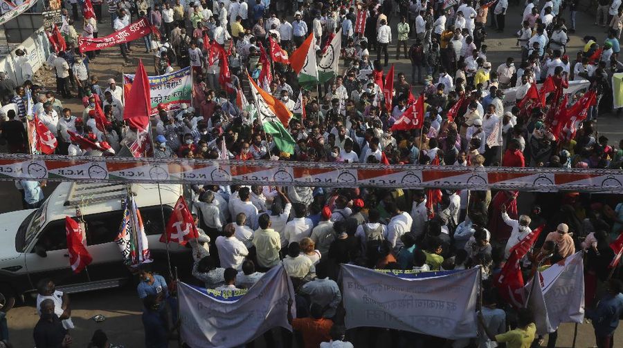 A woman participates in a protest against new farm laws in Mumbai, India, Saturday, Feb. 6, 2021. Tens of thousands of protesting Indian farmers blocked highways across the country for three hours Saturday to press their demands for the repeal of new agricultural laws. (AP Photo/Rafiq Maqbool)
