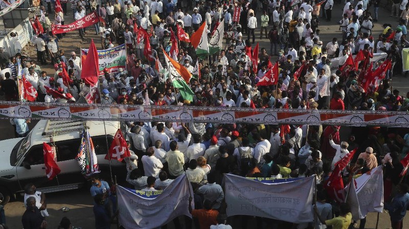 A woman participates in a protest against new farm laws in Mumbai, India, Saturday, Feb. 6, 2021. Tens of thousands of protesting Indian farmers blocked highways across the country for three hours Saturday to press their demands for the repeal of new agricultural laws. (AP Photo/Rafiq Maqbool)