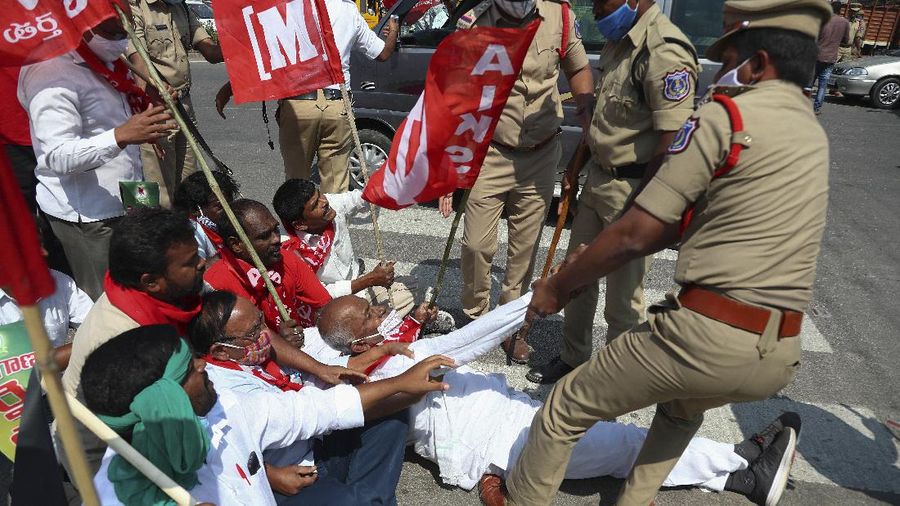 A woman participates in a protest against new farm laws in Mumbai, India, Saturday, Feb. 6, 2021. Tens of thousands of protesting Indian farmers blocked highways across the country for three hours Saturday to press their demands for the repeal of new agricultural laws. (AP Photo/Rafiq Maqbool)