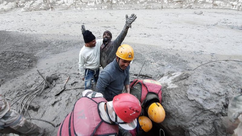 This photograph provided by Indo Tibetan Border Police (ITBP) shows ITBP personnel arriving for rescue work after a portion of Nanda Devi glacier broke off in Tapovan area of the northern state of Uttarakhand sending a massive flood of water, mud and debris into areas below, India, Sunday, Feb.7, 2021. (Indo Tibetan Border Police via AP)