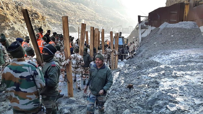This photograph provided by National Disaster Response Force shows NDRF personnel prepare to rescue workers at one of the hydropower project at Reni village in Chamoli district of Indian state of Uttrakhund, Monday, Feb. 8, 2021. Rescue efforts continued on Monday to save 37 people after part of a glacier broke off, releasing a torrent of water and debris that slammed into two hydroelectric plants on Sunday. (National Disaster Response Force via AP)