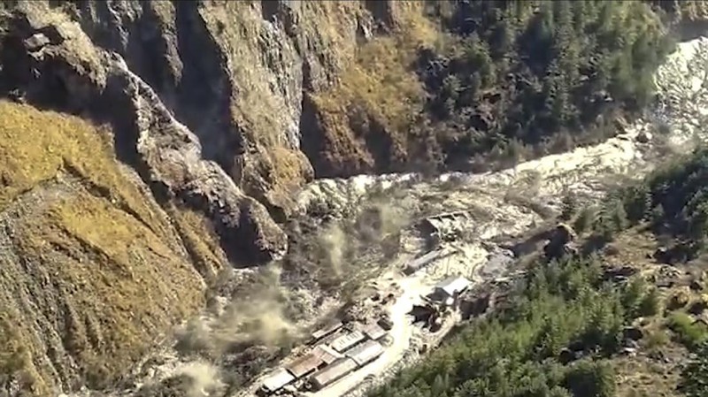 This photograph provided by Indo Tibetan Border Police (ITBP) shows ITBP personnel arriving for rescue work after a portion of Nanda Devi glacier broke off in Tapovan area of the northern state of Uttarakhand sending a massive flood of water, mud and debris into areas below, India, Sunday, Feb.7, 2021. (Indo Tibetan Border Police via AP)