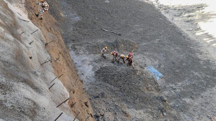 This photograph provided by Indo Tibetan Border Police (ITBP) shows ITBP personnel arriving for rescue work after a portion of Nanda Devi glacier broke off in Tapovan area of the northern state of Uttarakhand sending a massive flood of water, mud and debris into areas below, India, Sunday, Feb.7, 2021. (Indo Tibetan Border Police via AP)