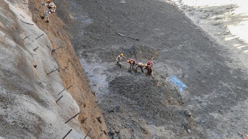 This photograph provided by Indo Tibetan Border Police (ITBP) shows ITBP personnel arriving for rescue work after a portion of Nanda Devi glacier broke off in Tapovan area of the northern state of Uttarakhand sending a massive flood of water, mud and debris into areas below, India, Sunday, Feb.7, 2021. (Indo Tibetan Border Police via AP)