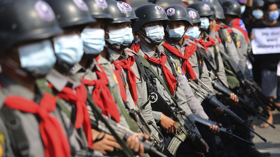 Protesters are sprayed with water fired from a police truck's water cannon in Naypyitaw, Myanmar on Monday, Feb. 8, 2021. Tension in the confrontations between the authorities and demonstrators against last week's coup in Myanmar boiled over Monday, as police fired a water cannon at peaceful protesters in the capital Naypyitaw.(AP Photo)