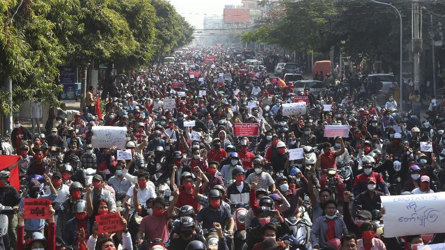 A crowd of protesters fill a street and a bridge in Mandalay, Myanmar on Sunday, Feb. 7, 2021. Tens of thousands of people rallied against the military takeover in Myanmar's biggest city on Yangon Sunday and demanded the release of Aung San Suu Kyi, whose elected government was toppled by the army that also imposed an internet blackout. (AP Photo)