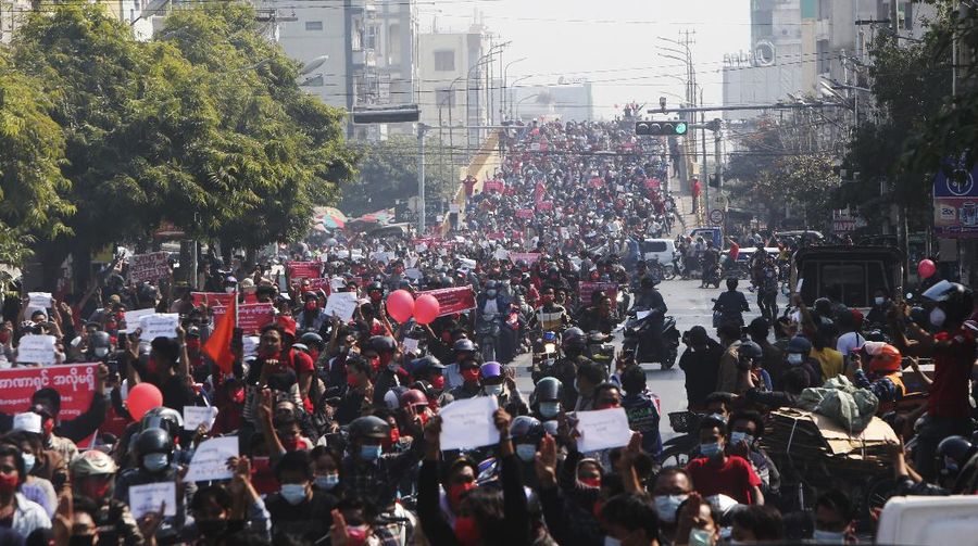 A crowd of protesters fill a street and a bridge in Mandalay, Myanmar on Sunday, Feb. 7, 2021. Tens of thousands of people rallied against the military takeover in Myanmar's biggest city on Yangon Sunday and demanded the release of Aung San Suu Kyi, whose elected government was toppled by the army that also imposed an internet blackout. (AP Photo)