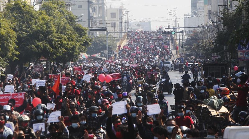 A crowd of protesters fill a street and a bridge in Mandalay, Myanmar on Sunday, Feb. 7, 2021. Tens of thousands of people rallied against the military takeover in Myanmar's biggest city on Yangon Sunday and demanded the release of Aung San Suu Kyi, whose elected government was toppled by the army that also imposed an internet blackout. (AP Photo)