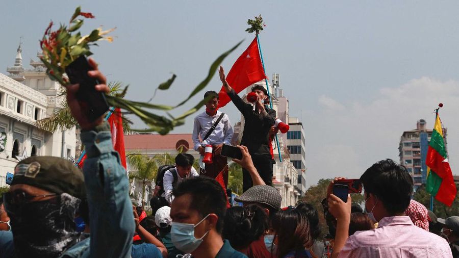 A crowd of protesters fill a street and a bridge in Mandalay, Myanmar on Sunday, Feb. 7, 2021. Tens of thousands of people rallied against the military takeover in Myanmar's biggest city on Yangon Sunday and demanded the release of Aung San Suu Kyi, whose elected government was toppled by the army that also imposed an internet blackout. (AP Photo)