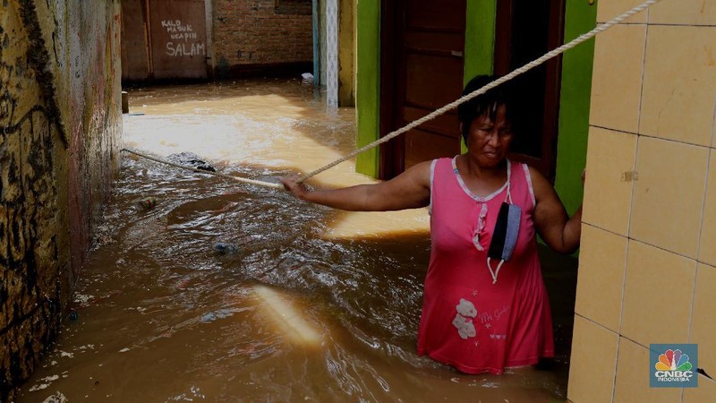 Tim SAR mengevakuasi warga yang terjebak banjir di kampung Kebon Pala, Jakarta, Senin (8/2/2021). (CNBC Indonesia/Tri Susilo)