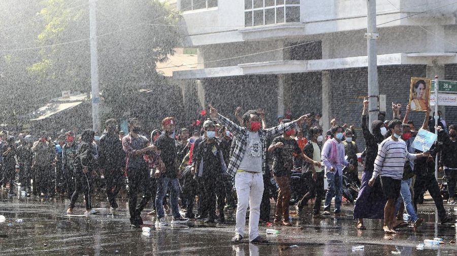 Protesters regroup after police fired warning-shots and used a water cannon to disperse them during a protest in Mandalay, Myanmar on Tuesday, Feb. 9, 2021. Police cracked down Tuesday on the demonstrators protesting against Myanmar’s military takeover who took to the streets in defiance of new protest bans. (AP Photo)