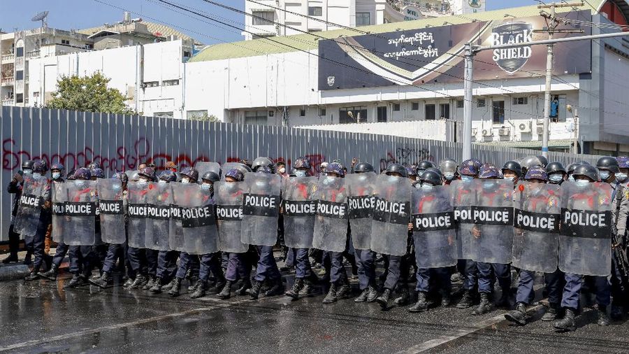Protesters regroup after police fired warning-shots and used a water cannon to disperse them during a protest in Mandalay, Myanmar on Tuesday, Feb. 9, 2021. Police cracked down Tuesday on the demonstrators protesting against Myanmar’s military takeover who took to the streets in defiance of new protest bans. (AP Photo)