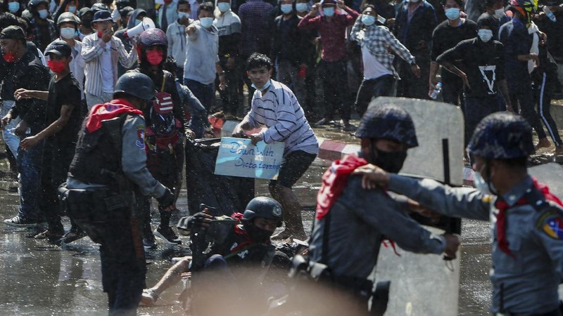 Protesters regroup after police fired warning-shots and used a water cannon to disperse them during a protest in Mandalay, Myanmar on Tuesday, Feb. 9, 2021. Police cracked down Tuesday on the demonstrators protesting against Myanmar’s military takeover who took to the streets in defiance of new protest bans. (AP Photo)