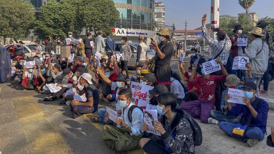 Campaigners display placards at an intersection in Yangon, Myanmar, Tuesday, Feb. 9, 2021. Protesters continued to gather Tuesday morning in Yangon breaching Myanmar's new military rulers ban of public gathering of five or more issued on Monday intended to crack down on peaceful public protests opposing their takeover. (AP Photo)
