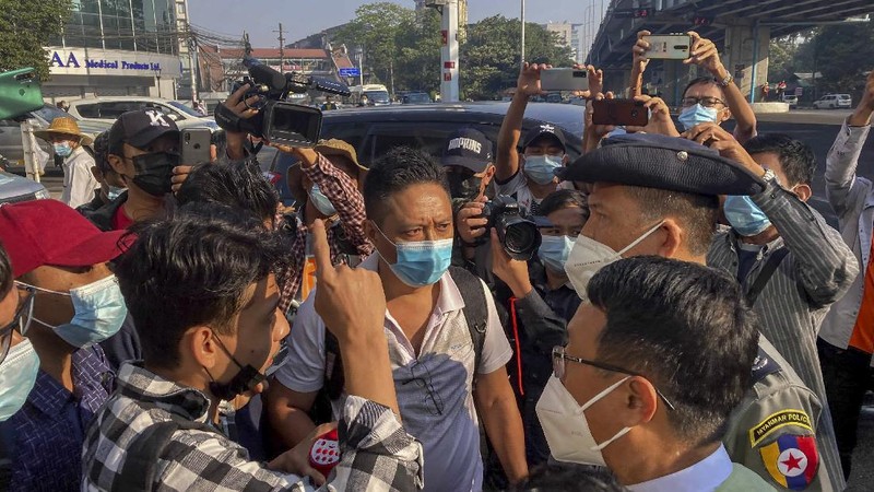 Campaigners display placards at an intersection in Yangon, Myanmar, Tuesday, Feb. 9, 2021. Protesters continued to gather Tuesday morning in Yangon breaching Myanmar's new military rulers ban of public gathering of five or more issued on Monday intended to crack down on peaceful public protests opposing their takeover. (AP Photo)