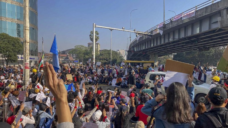 Campaigners display placards at an intersection in Yangon, Myanmar, Tuesday, Feb. 9, 2021. Protesters continued to gather Tuesday morning in Yangon breaching Myanmar's new military rulers ban of public gathering of five or more issued on Monday intended to crack down on peaceful public protests opposing their takeover. (AP Photo)