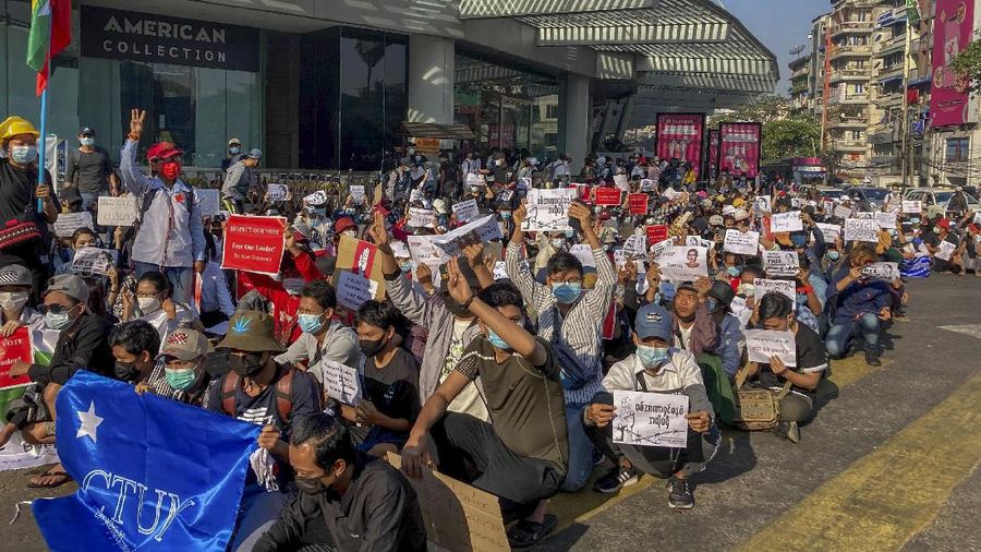 Campaigners display placards at an intersection in Yangon, Myanmar, Tuesday, Feb. 9, 2021. Protesters continued to gather Tuesday morning in Yangon breaching Myanmar's new military rulers ban of public gathering of five or more issued on Monday intended to crack down on peaceful public protests opposing their takeover. (AP Photo)