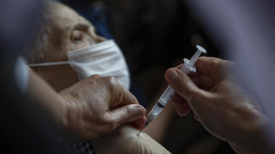 Health workers guide drivers to shots of China's Sinovac CoronaVac vaccine during a priority COVID-19 vaccination program for the elderly at a drive-thru set up in the Pacaembu soccer stadium parking lot in Sao Paulo, Brazil, Monday, Feb. 8, 2021. (AP Photo/Andre Penner)
