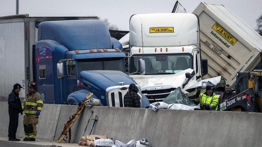 A crumbled car is towed as emergency crews work to clear the pile-up on Interstate 35 in Fort Worth, Texas on Thursday, Feb. 11, 2021. A massive crash involving more than 130 vehicles on the icy Texas interstate left at least six people dead and dozens injured amid a winter storm that dropped freezing rain, sleet and snow on parts of the U.S. (Juan Figueroa/The Dallas Morning News via AP)