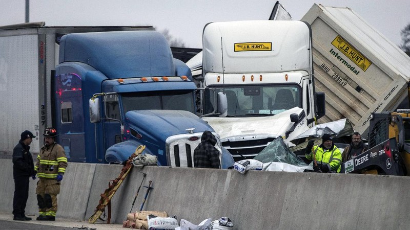 A crumbled car is towed as emergency crews work to clear the pile-up on Interstate 35 in Fort Worth, Texas on Thursday, Feb. 11, 2021. A massive crash involving more than 130 vehicles on the icy Texas interstate left at least six people dead and dozens injured amid a winter storm that dropped freezing rain, sleet and snow on parts of the U.S. (Juan Figueroa/The Dallas Morning News via AP)