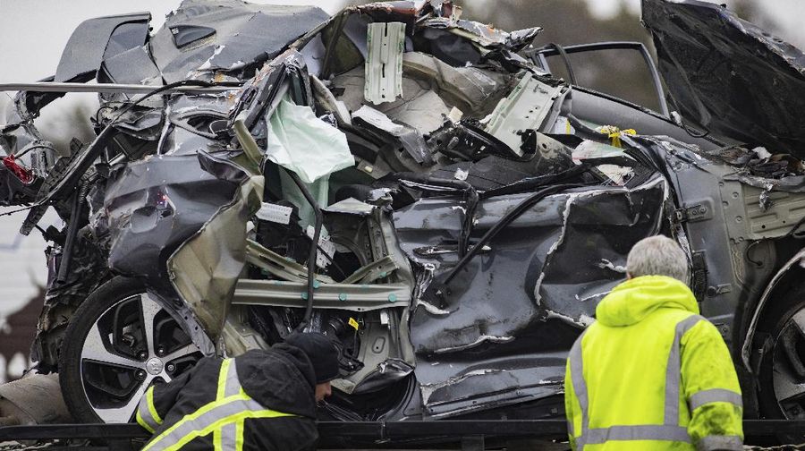 A crumbled car is towed as emergency crews work to clear the pile-up on Interstate 35 in Fort Worth, Texas on Thursday, Feb. 11, 2021. A massive crash involving more than 130 vehicles on the icy Texas interstate left at least six people dead and dozens injured amid a winter storm that dropped freezing rain, sleet and snow on parts of the U.S. (Juan Figueroa/The Dallas Morning News via AP)