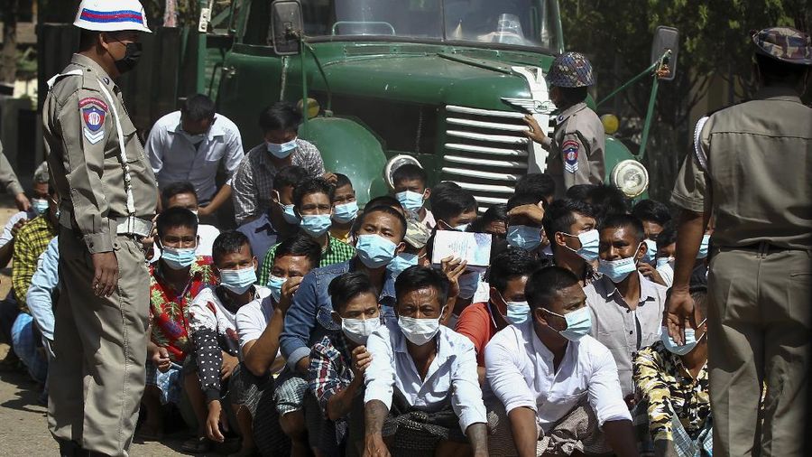 Prisoners, soon to be released marking the 74th anniversary of Myanmar's Union Day, wait for processing at the Insein prison in Yangon, Myanmar Friday, Feb. 12, 2021. Myanmar's coup leader used the country's Union Day holiday on Friday to call on people to work with the military if they want democracy, a request likely to be met with derision by protesters who are pushing for the release from detention of their country's elected leaders. (AP Photo)