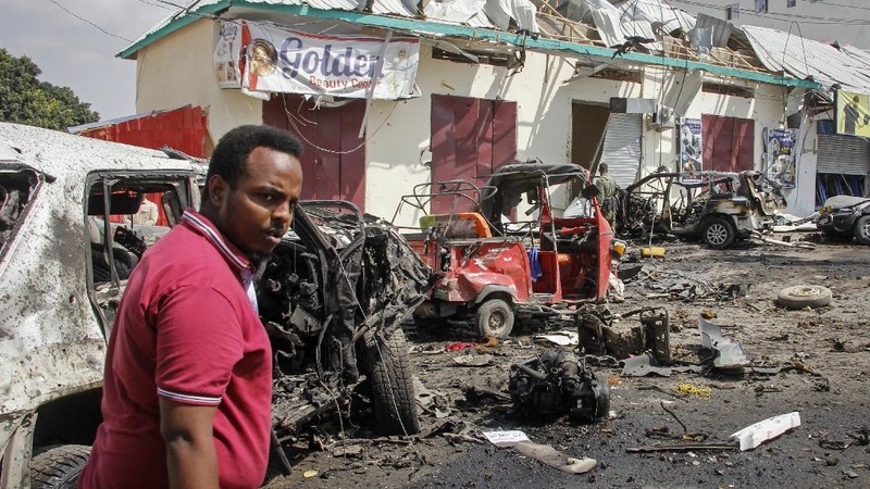 Rescuers at the scene of a bombing in Mogadishu, Somalia Saturday, Feb. 13, 2021. Police say a suicide bomber died and a number of civilians were wounded when a vehicle exploded near a checkpoint outside the presidential palace in Somalia's capital, Mogadishu. (AP Photo/Farah Abdi Warsameh)