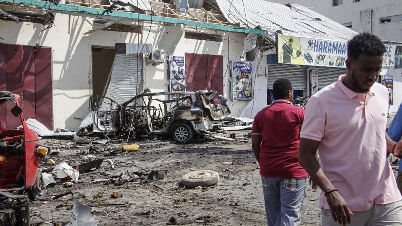 Rescuers at the scene of a bombing in Mogadishu, Somalia Saturday, Feb. 13, 2021. Police say a suicide bomber died and a number of civilians were wounded when a vehicle exploded near a checkpoint outside the presidential palace in Somalia's capital, Mogadishu. (AP Photo/Farah Abdi Warsameh)