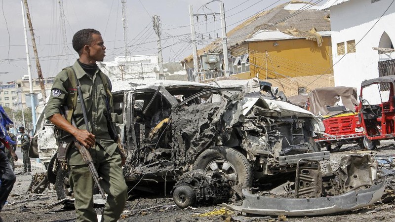 Rescuers at the scene of a bombing in Mogadishu, Somalia Saturday, Feb. 13, 2021. Police say a suicide bomber died and a number of civilians were wounded when a vehicle exploded near a checkpoint outside the presidential palace in Somalia's capital, Mogadishu. (AP Photo/Farah Abdi Warsameh)