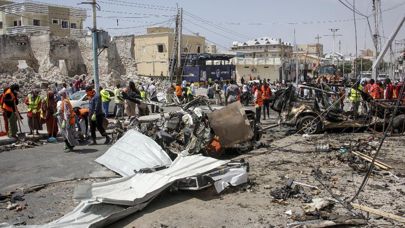 Rescuers at the scene of a bombing in Mogadishu, Somalia Saturday, Feb. 13, 2021. Police say a suicide bomber died and a number of civilians were wounded when a vehicle exploded near a checkpoint outside the presidential palace in Somalia's capital, Mogadishu. (AP Photo/Farah Abdi Warsameh)