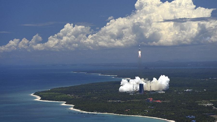 In this July 23, 2020, file photo released by China's Xinhua News Agency, spectators watch as a Long March-5 rocket carrying the Tianwen-1 Mars probe lifts off from the Wenchang Space Launch Center in southern China's Hainan Province. China is falling in love with space, inspired by the ruling Communist Party's increasingly ambitious missions over the past two decades to fire humans into orbit and explore the moon and Mars. (Yang Guanyu/Xinhua via AP, File)