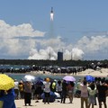 In this July 23, 2020, file photo released by China's Xinhua News Agency, spectators watch as a Long March-5 rocket carrying the Tianwen-1 Mars probe lifts off from the Wenchang Space Launch Center in southern China's Hainan Province. China is fallin