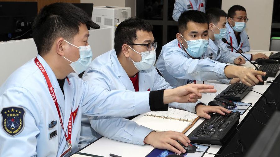 In this July 23, 2020, file photo released by China's Xinhua News Agency, spectators watch as a Long March-5 rocket carrying the Tianwen-1 Mars probe lifts off from the Wenchang Space Launch Center in southern China's Hainan Province. China is falling in love with space, inspired by the ruling Communist Party's increasingly ambitious missions over the past two decades to fire humans into orbit and explore the moon and Mars. (Yang Guanyu/Xinhua via AP, File)