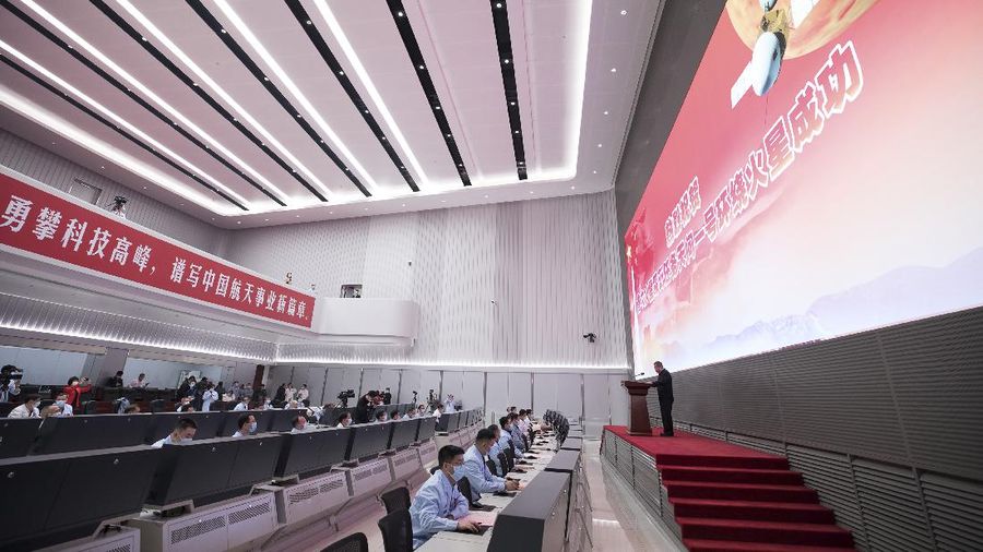 In this July 23, 2020, file photo released by China's Xinhua News Agency, spectators watch as a Long March-5 rocket carrying the Tianwen-1 Mars probe lifts off from the Wenchang Space Launch Center in southern China's Hainan Province. China is falling in love with space, inspired by the ruling Communist Party's increasingly ambitious missions over the past two decades to fire humans into orbit and explore the moon and Mars. (Yang Guanyu/Xinhua via AP, File)