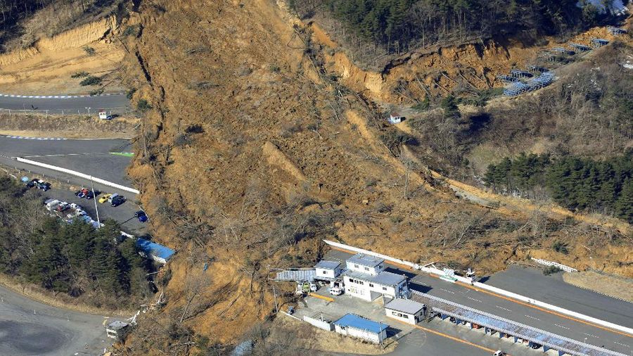 A landslide caused by a strong earthquake covers a circuit course in Nihonmatsu city, Fukushima prefecture, northeastern Japan, Sunday, Feb. 14, 2021. The strong earthquake shook the quake-prone areas of Fukushima and Miyagi prefectures late Saturday, setting off landslides and causing power blackouts for thousands of people. (Hironori Asakawa/Kyodo News via AP)