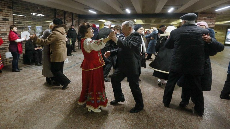Elderly people dance in a pedestrian subway to mark Valentine's Day ignoring coronavirus quarantine restrictions in Kyiv, Ukraine, Sunday, Feb. 14, 2021. (AP Photo/Efrem Lukatsky)