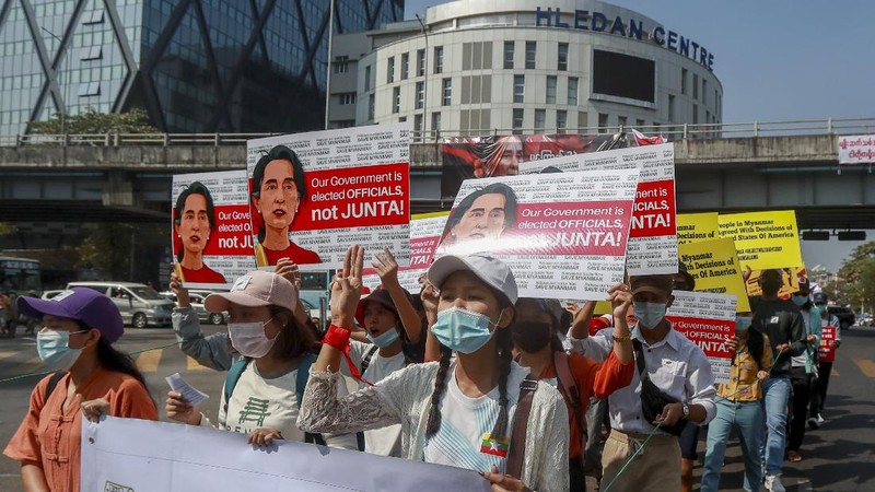 Demonstrators display images of detained Myanmar leader Aung San Suu Kyi during a protest against the military coup in Yangon, Myanmar Tuesday, Feb. 16, 2021. Security forces in Myanmar pointed guns toward anti-coup protesters and attacked them with sticks Monday, seeking to quell the large-scale demonstrations calling for the military junta that seized power this month to reinstate the elected government. (AP Photo)