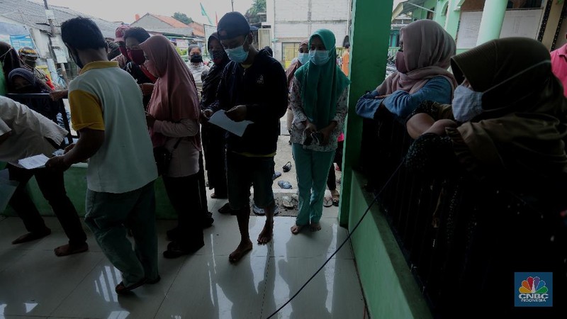 Warga menerima Bantuan Langsung Tunai (BLT) di Sawangan, Depok, Selasa (16/2/2021). Pemerintah melalui Kementerian Sosial (Kemensos) tahun ini melanjutkan penyaluran program Bantuan Sosial Tunai atau bantuan langsung tunai (BLT) secara bertahap melalui Kantor Pos. (CNBC Indonesia/Tri Susilo)