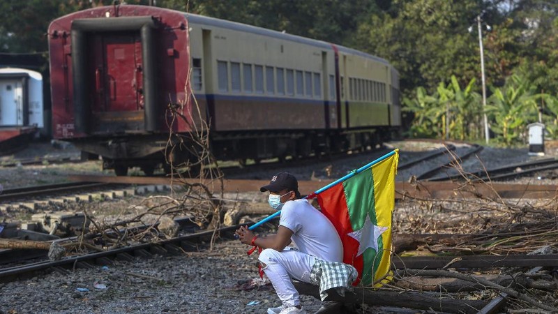 Demonstrators with placards lie on the railway tracks in an attempt to disrupt train service during a protest against the military coup in Mandalay, Myanmar on Wednesday, Feb. 17, 2021. Demonstrators in Myanmar gathered Wednesday in their largest numbers so far to protest the military’s seizure of power, even after a U.N. human rights expert warned that troops being brought to Yangon and elsewhere could signal the prospect of major violence. (AP Photo)