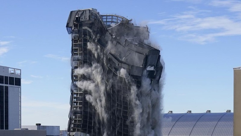 The former Trump Plaza Hotel & Casino implodes in Atlantic City, N.J., Wednesday, Feb 17, 2021.The former Trump Plaza casino was imploded after falling into such disrepair that chunks of the building began peeling off and crashing to the ground.  (Edward Lea/The Press of Atlantic City via AP)