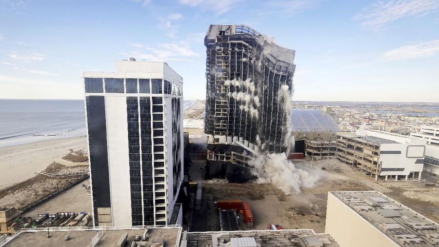 The former Trump Plaza Hotel & Casino implodes in Atlantic City, N.J., Wednesday, Feb 17, 2021. The former Trump Plaza casino was imploded after falling into such disrepair that chunks of the building began peeling off and crashing to the ground. (Edward Lea/The Press of Atlantic City via AP)