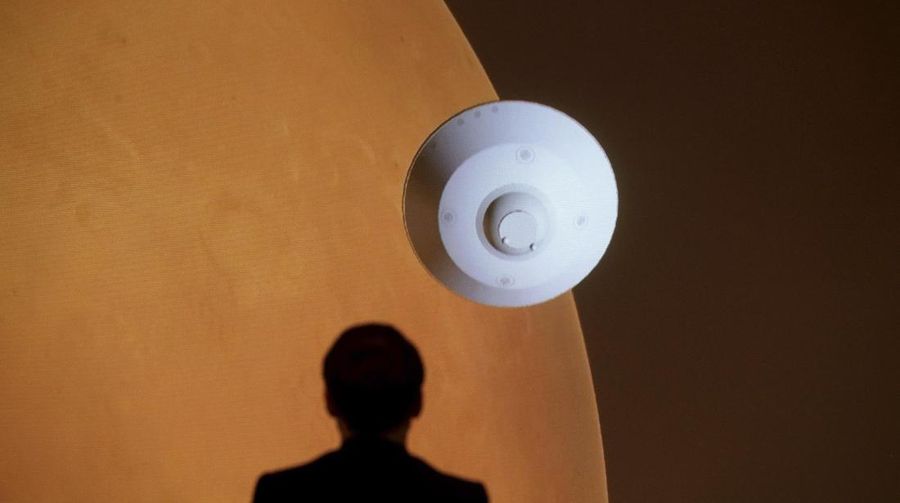 French President Emmanuel Macron attends a viewing meeting of the landing of the NASA Perseverance Mars rover on the planet Mars at the French National Center for Space Studies (CNES) in Paris, Thursday, Feb. 18 2021. A NASA rover streaked through the orange Martian sky and landed on the planet Thursday, accomplishing the riskiest step yet in an epic quest to bring back rocks that could answer whether life ever existed on Mars. The Perseverance rover carries the SuperCam instrument, built by a US-French team of several dozen engineers and scientists from CNES, CNRS and universities. (Christophe Petit Tesson, Pool via AP)