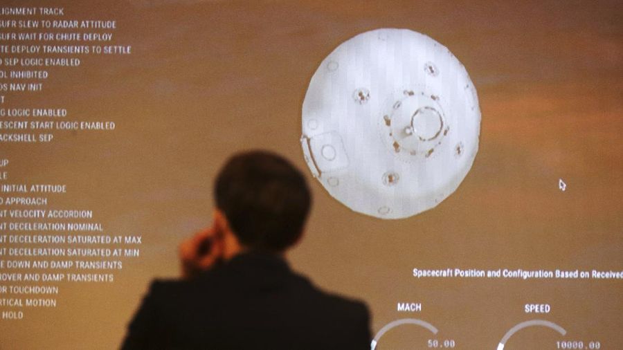In this photo provided by NASA, members of NASA's Perseverance Mars rover team watch in mission control as the first images arrive moments after the spacecraft successfully touched down on Mars, Thursday, Feb. 18, 2021, at NASA's Jet Propulsion Laboratory in Pasadena, Calif. (Bill Ingalls/NASA via AP)